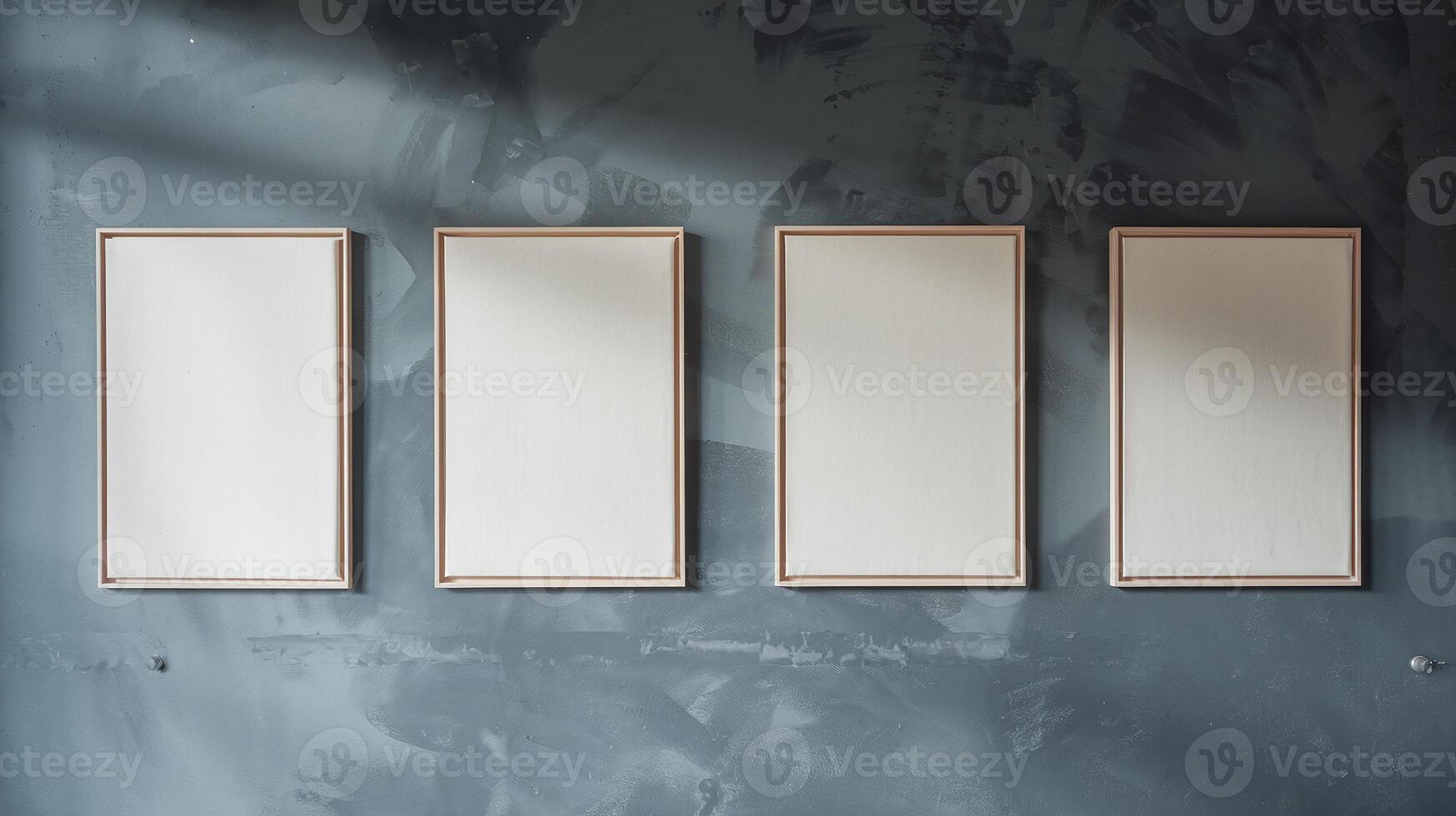 Four Blank Framed Canvas Artworks on Moody Gray Textured Wall with Natural Light Shadows photo