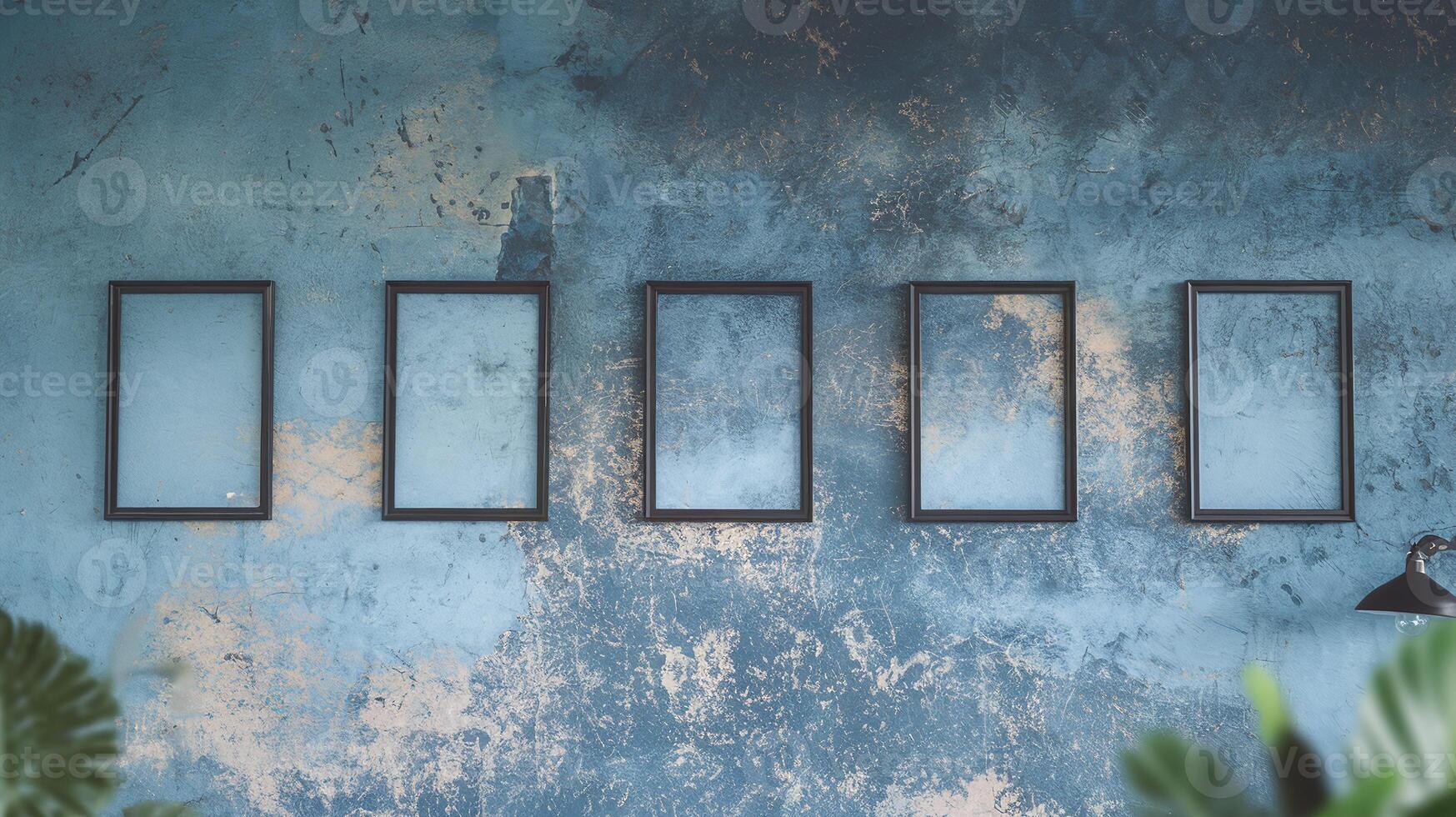 Empty Black Picture Frames on Vintage Textured Blue Wall with Abstract Design and Indoor Plants photo