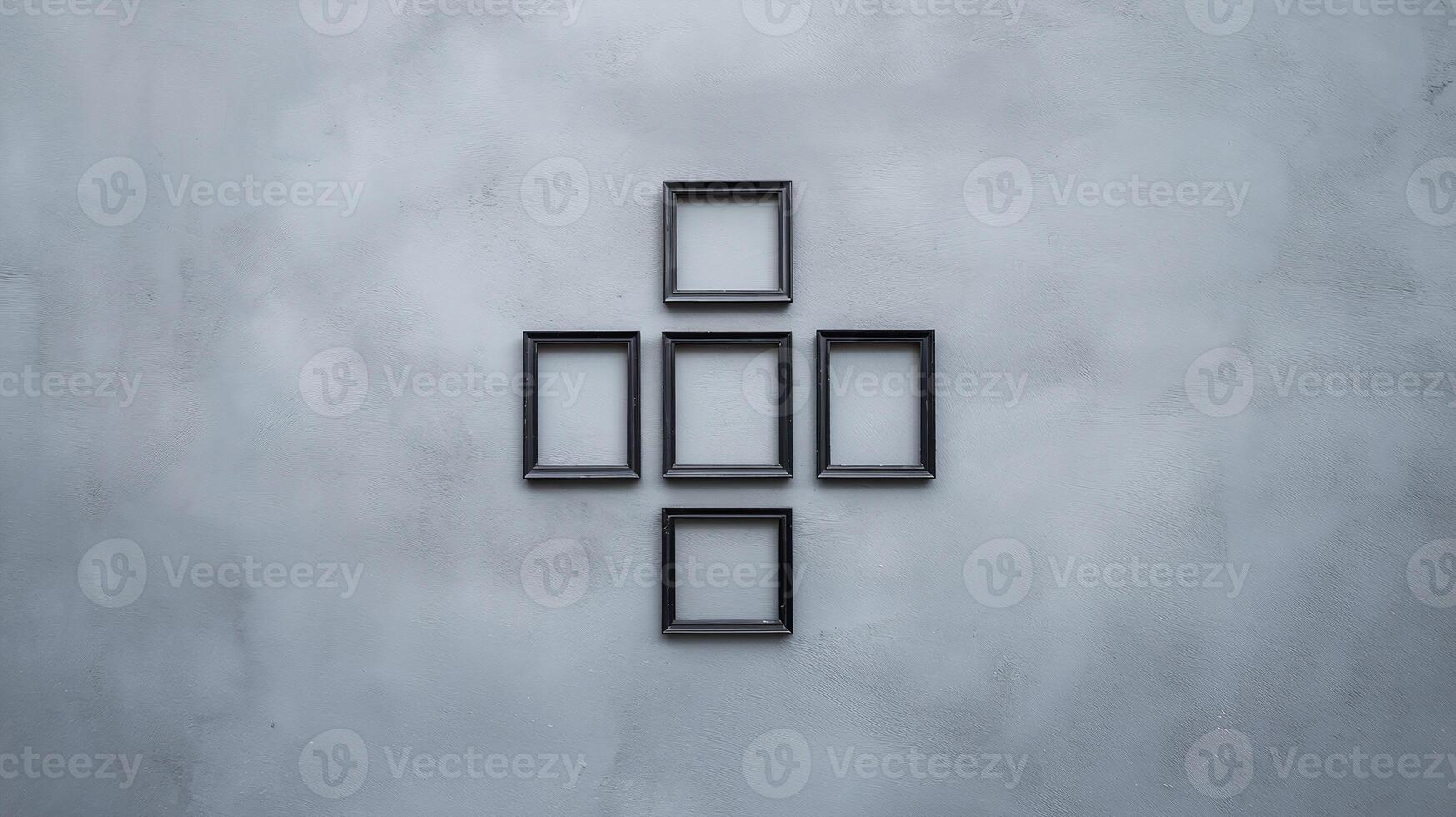 Minimalist Black Frames Arranged in Cross Formation on Gray Textured Wall Art Composition photo