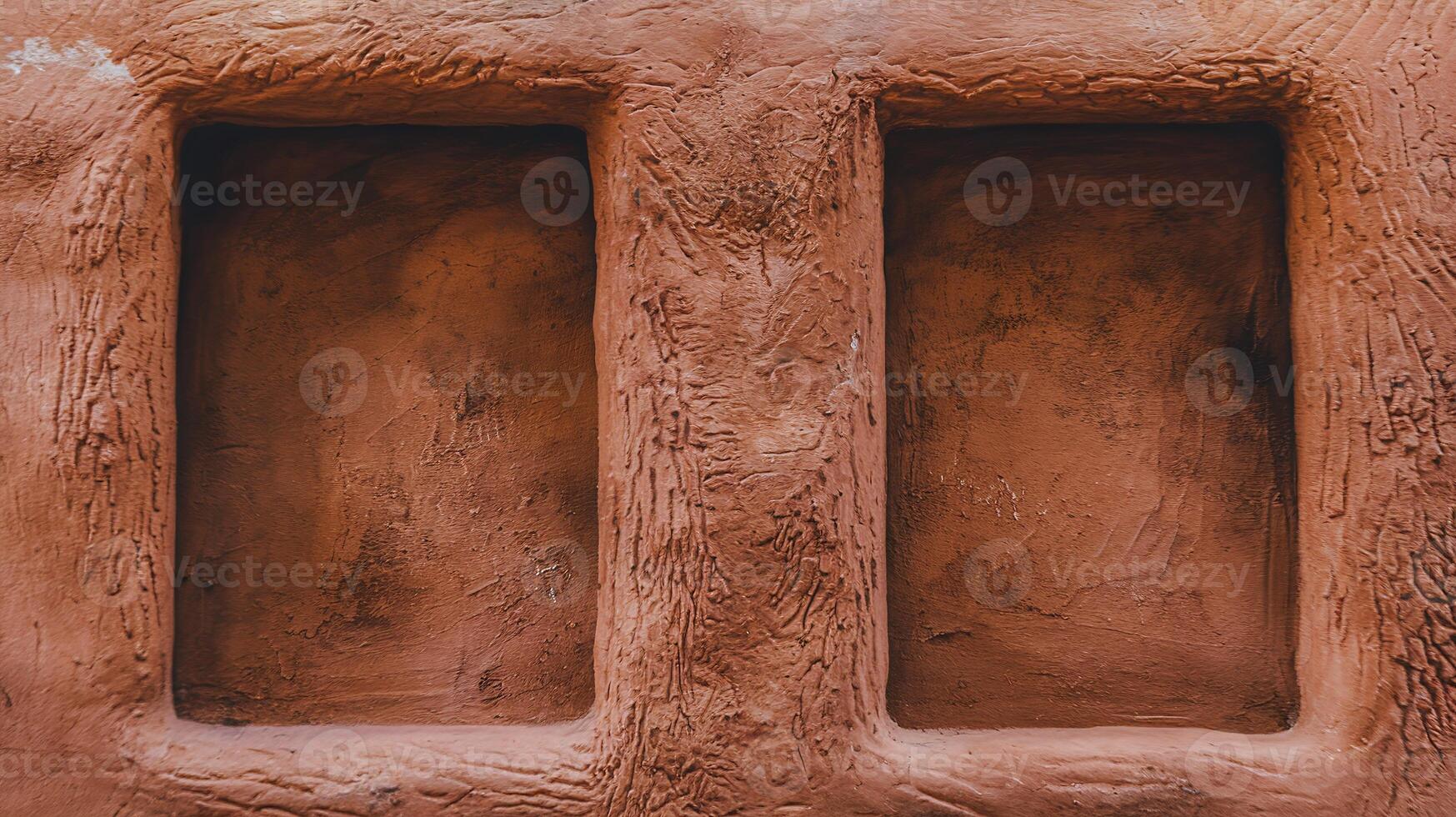 Closeup of Rustic Red Clay Wall with Two Recessed Rectangular Niches and Textured Surface photo