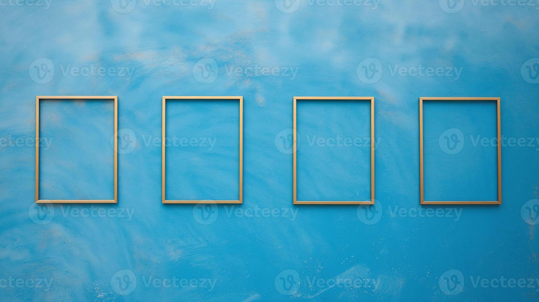 Four Empty Wooden Picture Frames Hanging on Vibrant Blue Textured Wall Minimal Art Decor photo