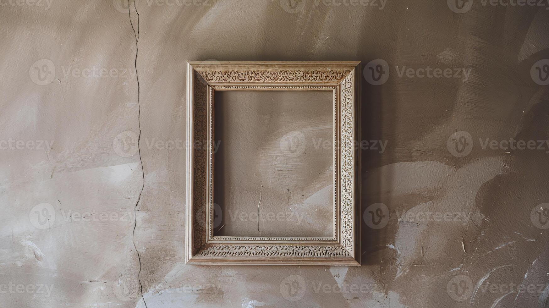 Ornate Empty Wooden Picture Frame Hanging On A Grungy Textured Beige Wall With Cracks And Stains photo