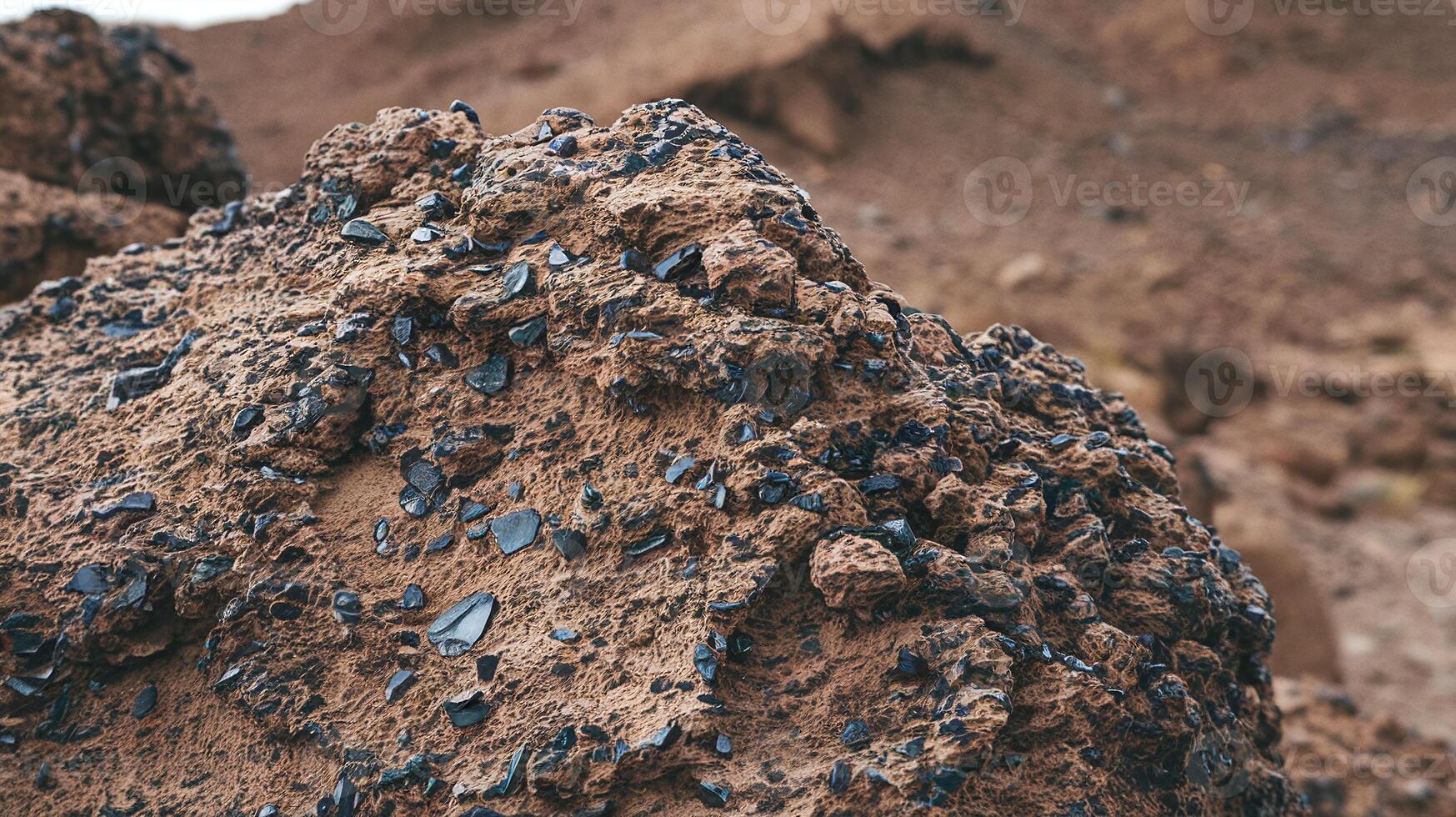 Closeup of Volcanic Rock Texture with Black Sharp Mineral Formations in Arid Desert Landscape photo