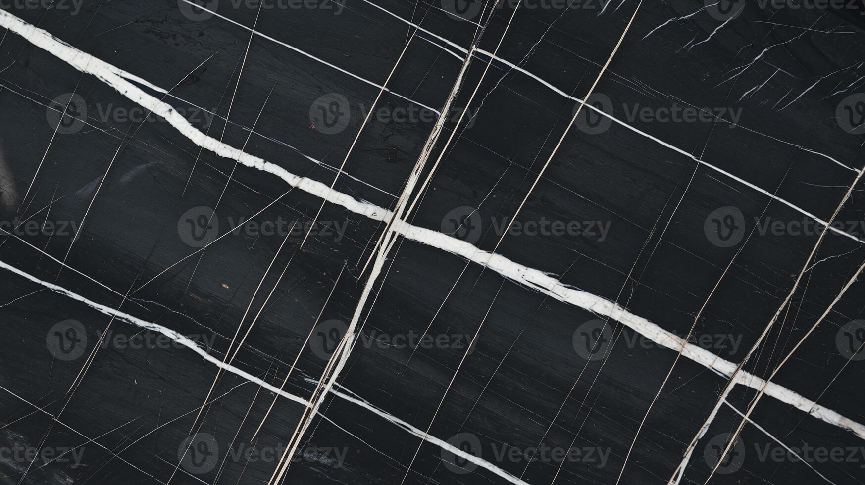 Closeup of Black Stone Surface with White and Gold Veins Abstract Natural Pattern Texture Background photo
