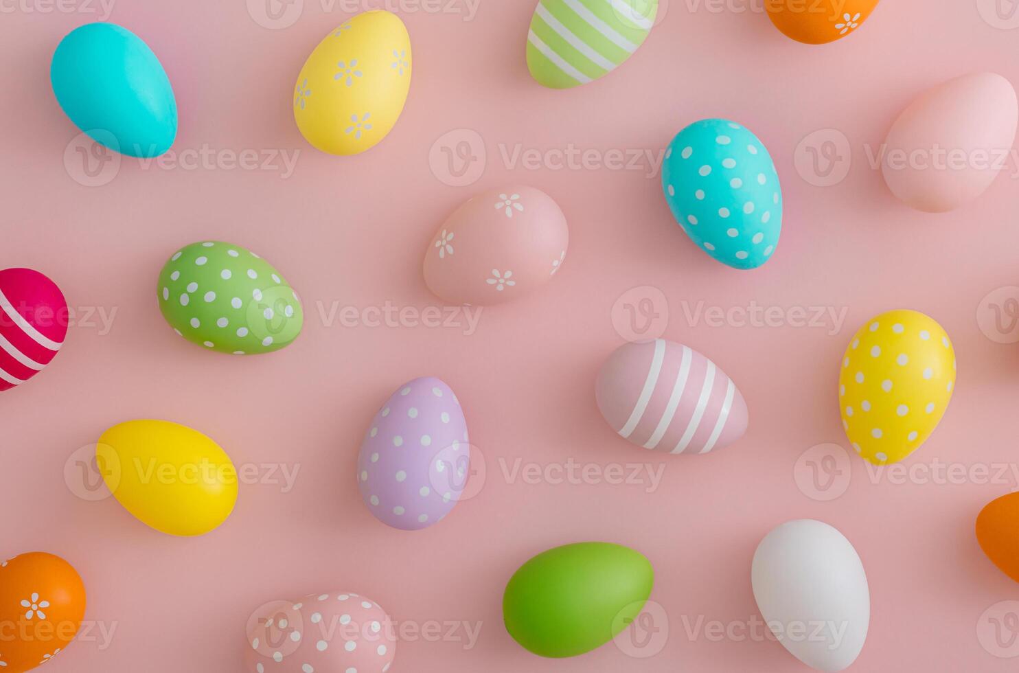 Creative Easter pattern composition made with colorful Easter eggs on light pastel pink background. Minimal Easter concept. Spring festive holiday pattern background. Flat lay, top of view. photo