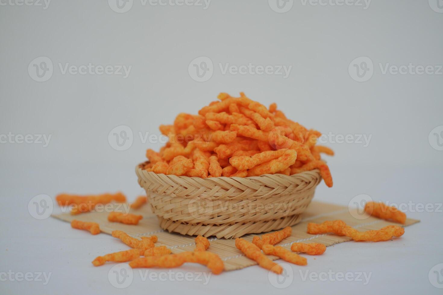 Crispy Corn Puffs in rattan on bamboo mat. Selective focus. photo