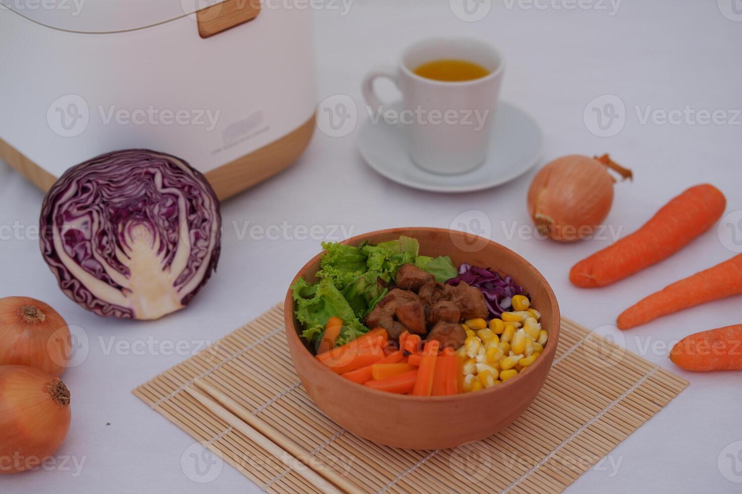A colorful dish featuring red rice, meat, corn, carrots, lettuce, and a sunny-side-up egg photo