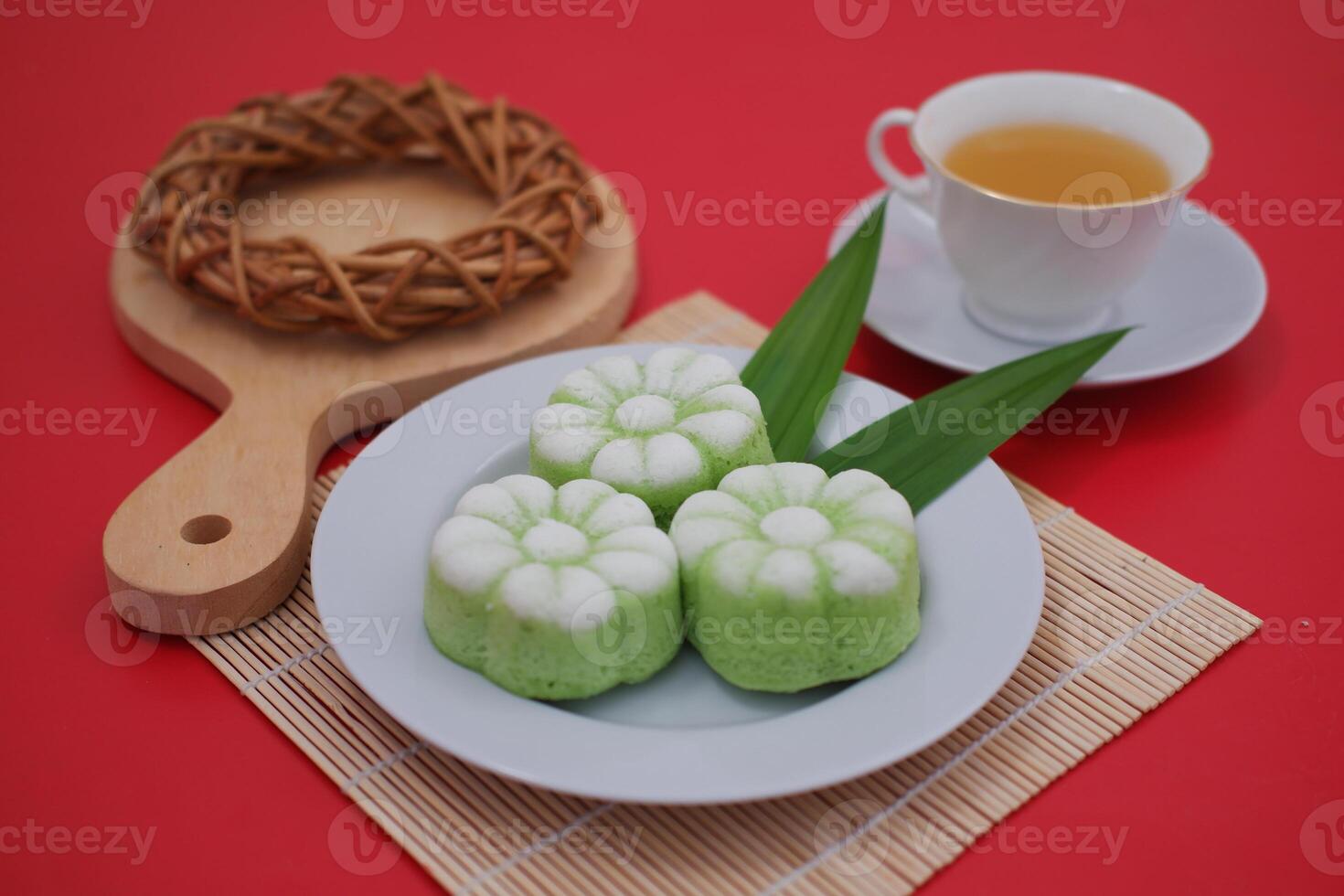 The cake is topped with grated coconut and steamed in small photo