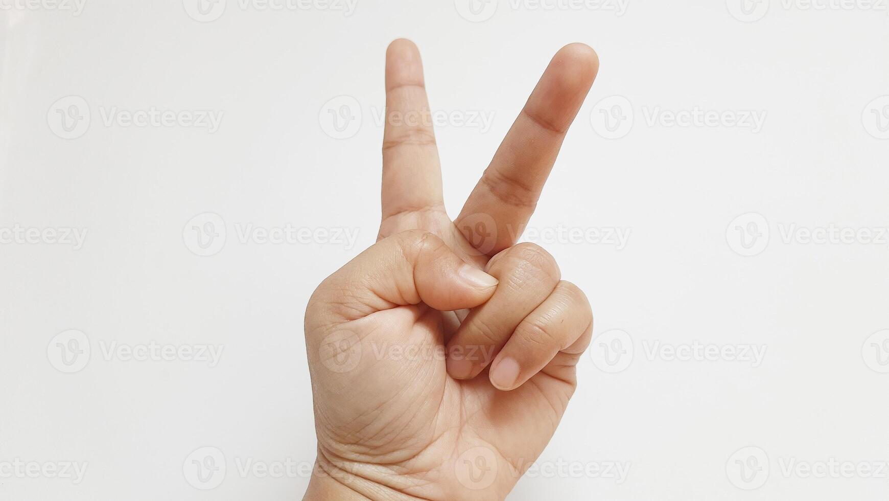Human hand showing finger number two. Isolated on white background photo