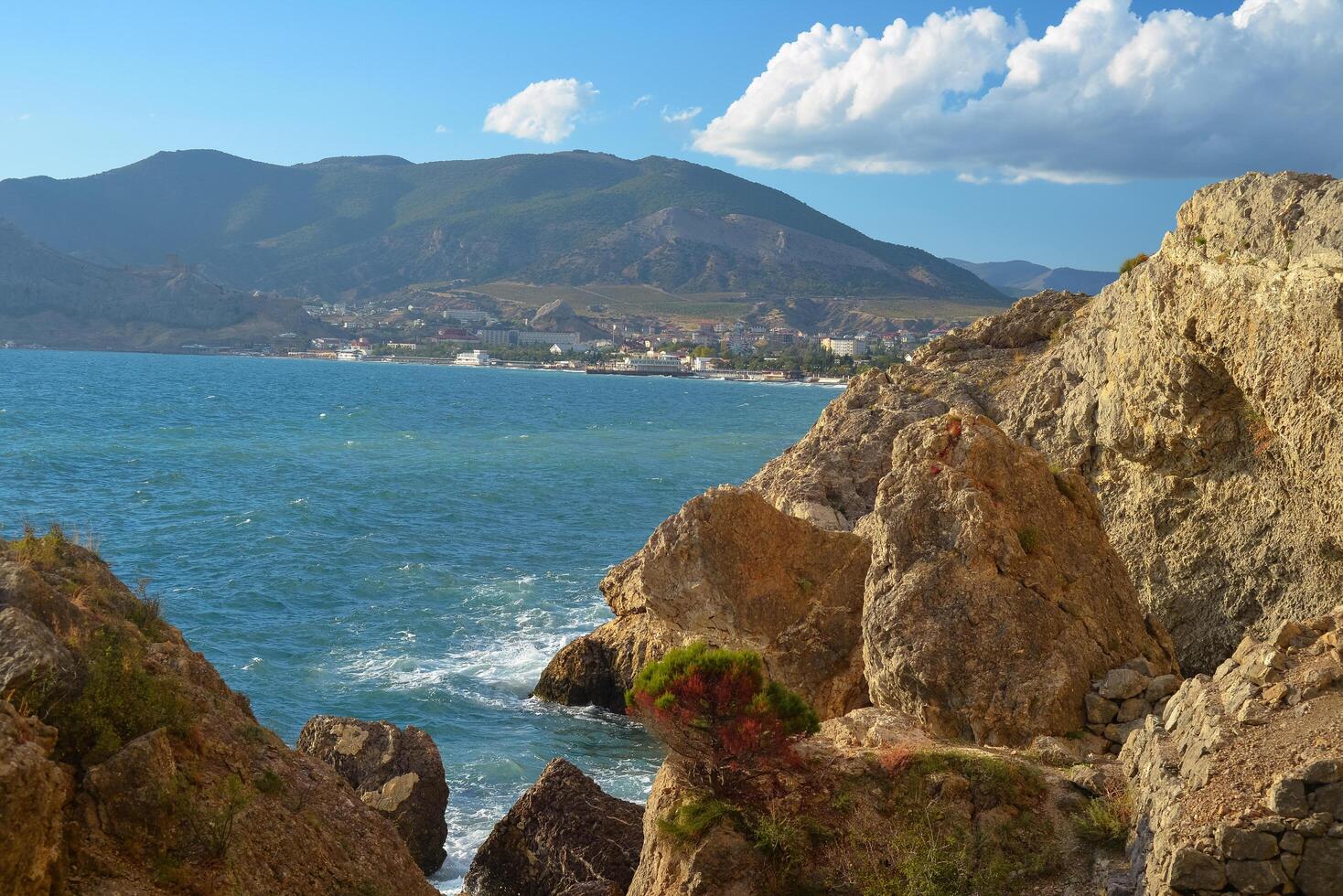 Background landscape view of Sudak Bay, the city of Sudak and its embankment in Crimea photo
