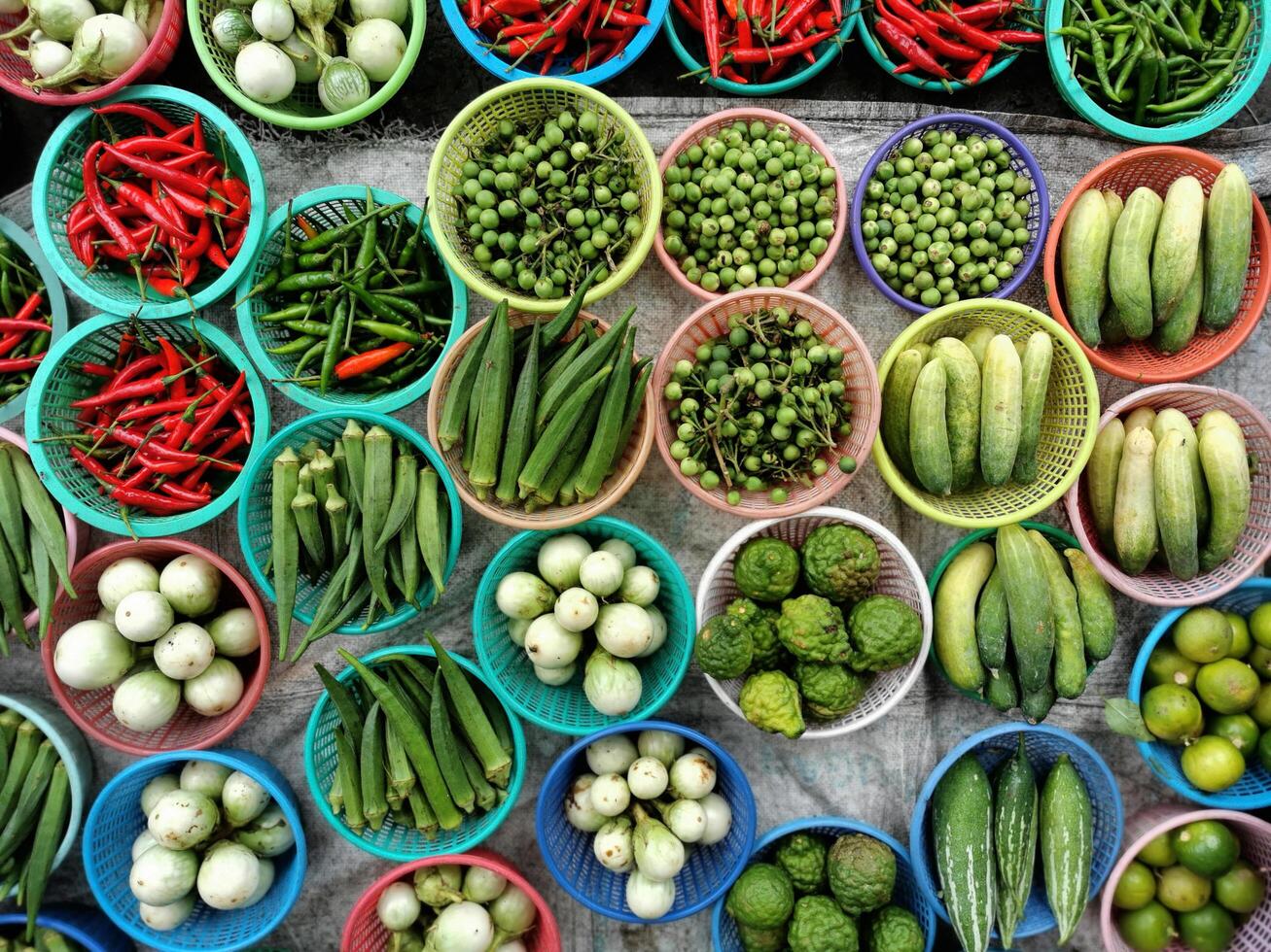 Many different types of vegetables are displayed in baskets photo