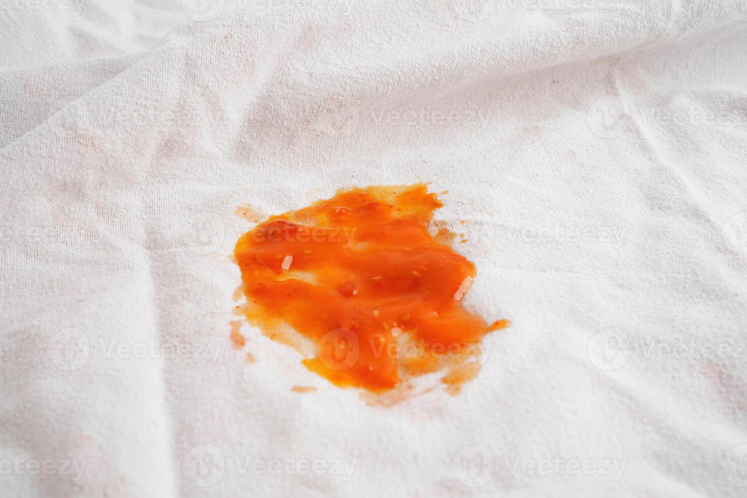 Dirty tomato sauce stain or ketchup on cloth to wash with washing powder, cleaning housework. photo