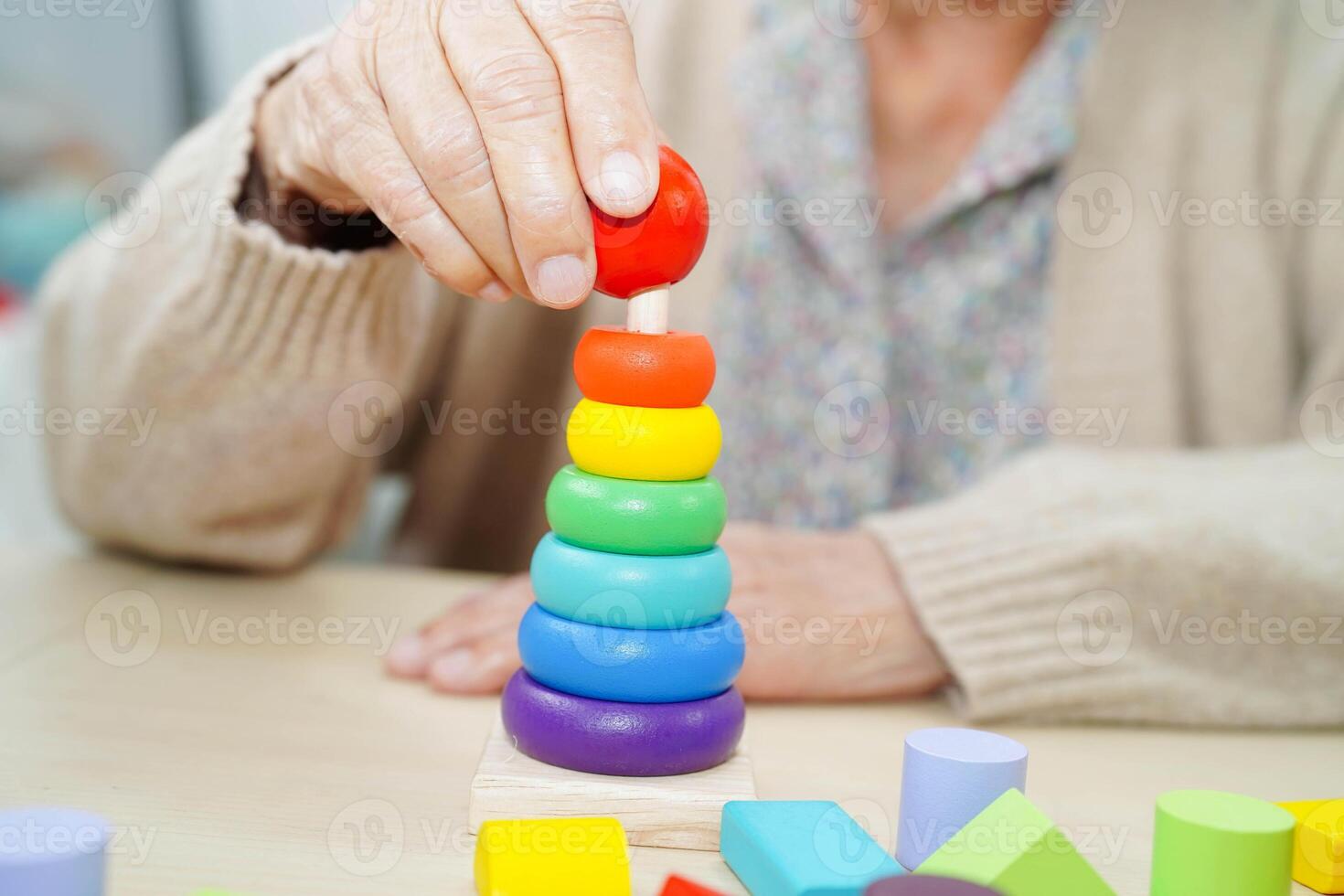 Asian elderly woman playing game in home. photo