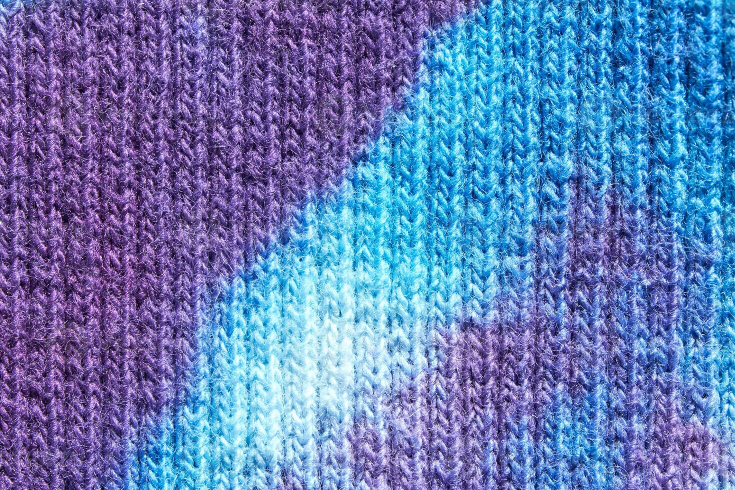 Close up of blue and purple tie dye knitted fabric texture pattern background. photo