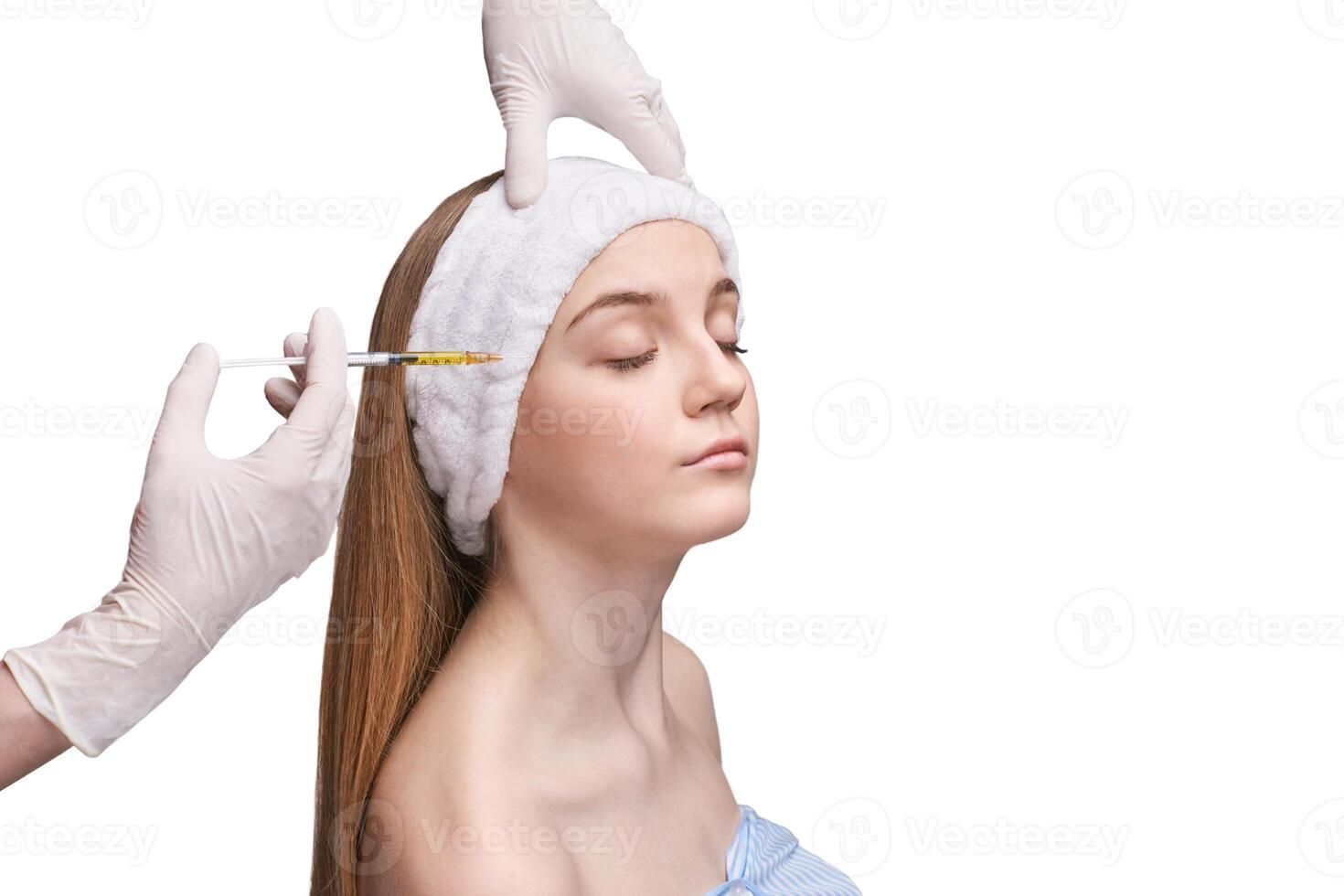 Young caucasian female receiving cosmetic injection beauty treatment. photo