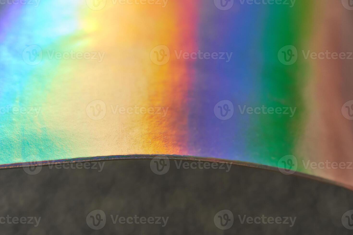 Close up of iridescent rainbow light on curved surface reflecting vibrant colors. photo