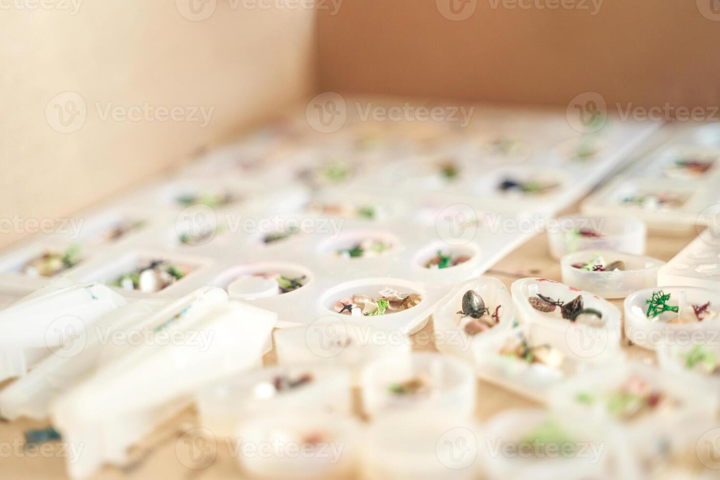 Close up of miniature figures on sculpting trays in a creative workshop setting. photo