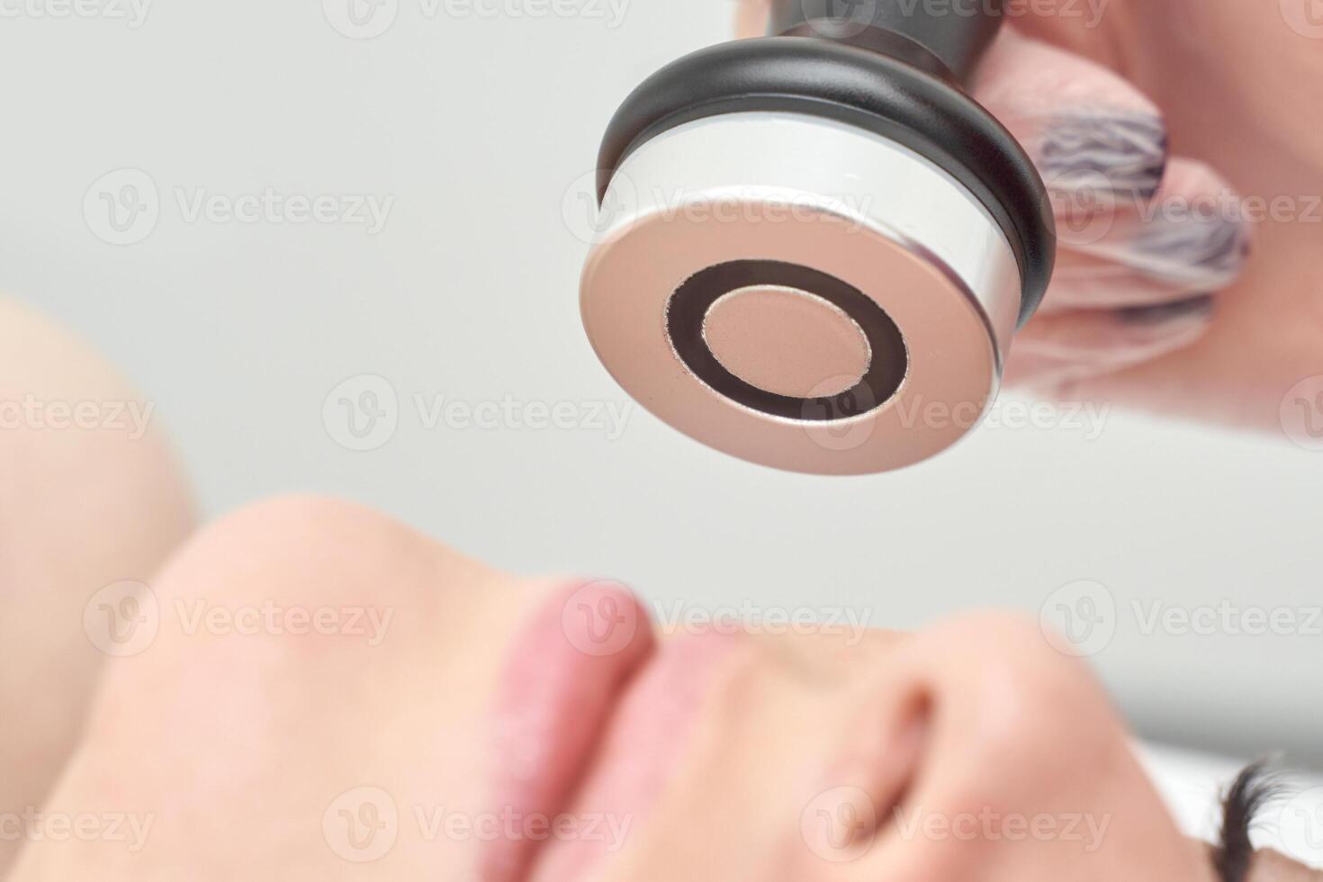 Facial treatment on young caucasian female with modern skincare device for rejuvenation. photo