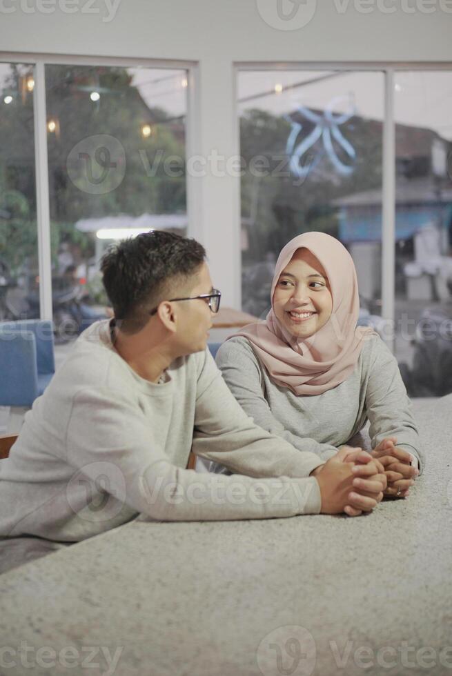 moslem couple relax sitting together in the kitchen photo