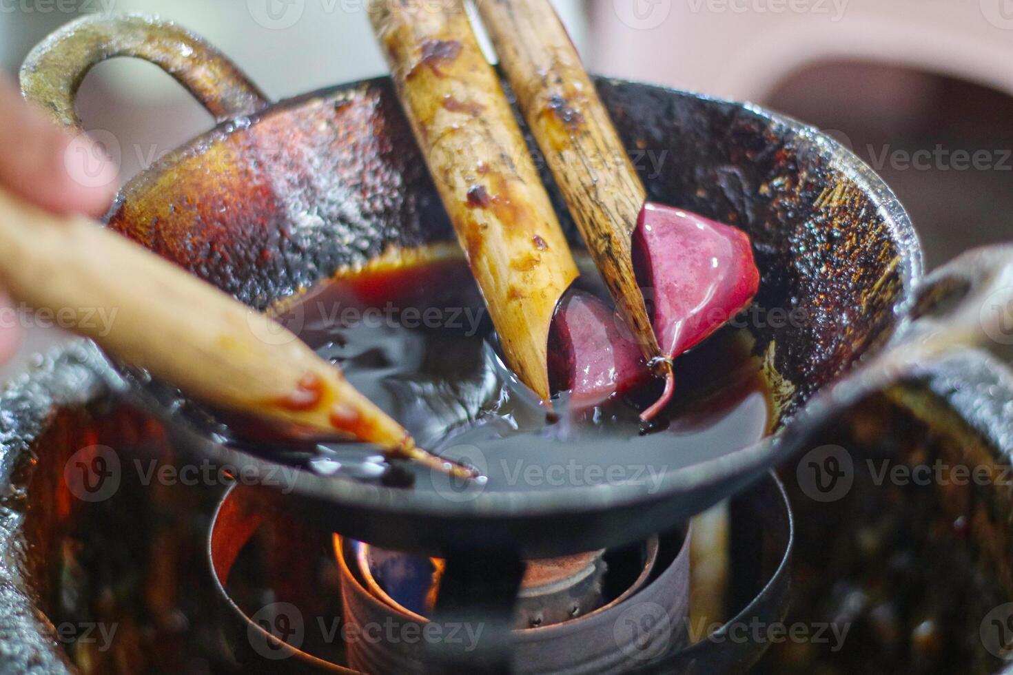 Canting and Batik wax liquid to make batik, tradisional Indonesia fabric. Canting is kind of pen to draw for batik photo