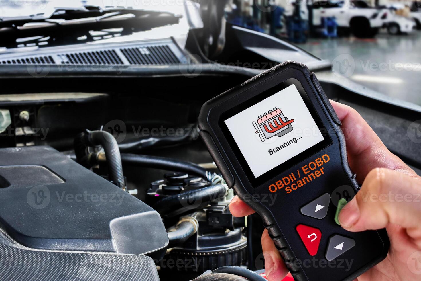 OBDII Scanner in use by auto mechanic for reading fault code of the car engine system , Car repair concept photo