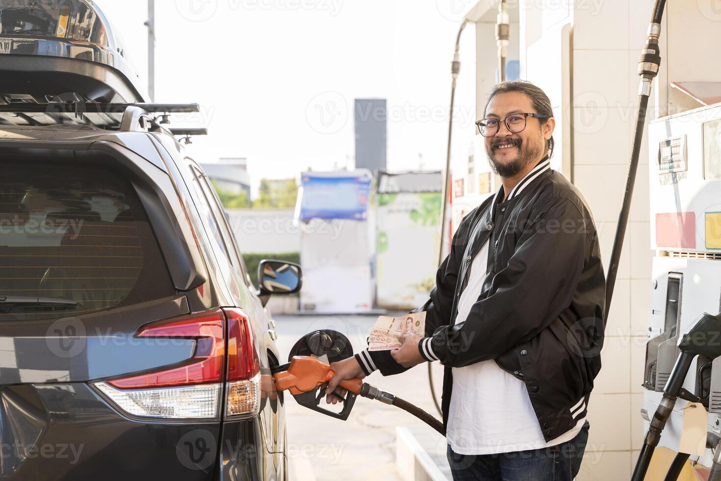 Filling fuel into a car at a petrol station pump. Car fueling at gas station. Refuel fill up with petrol gasoline. photo