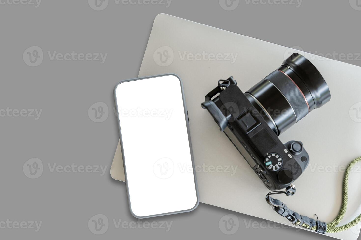 Top view of smartphone mock up screen on the white table with copy space. Camera on white table background. photo