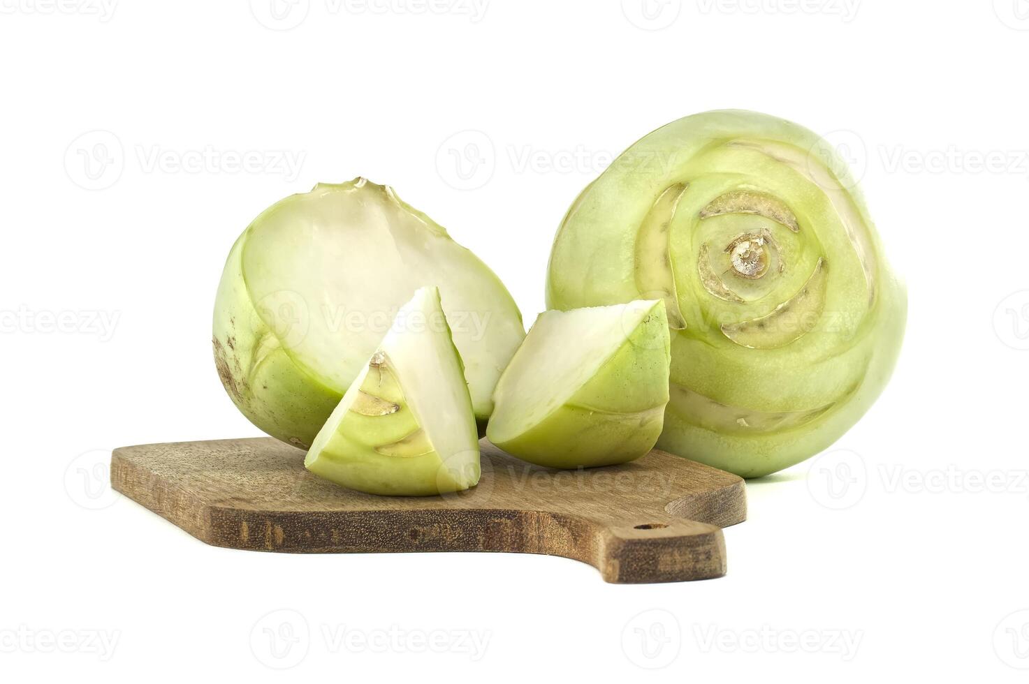 Fresh Kohlrabi Vegetable Slices on Wooden Cutting Board Isolated on White Background photo