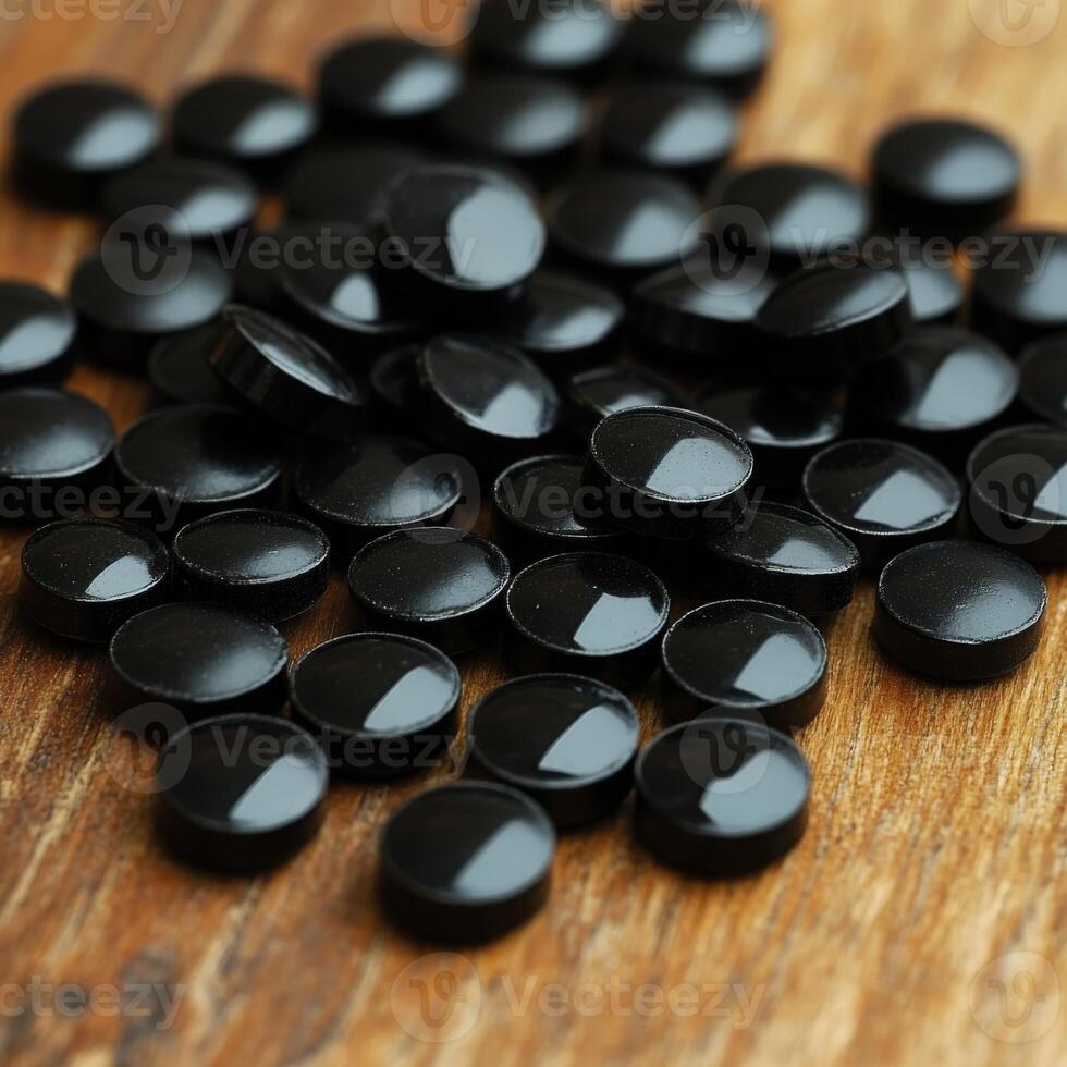 Round black capsules scattered on wooden surface creating an appealing texture photo