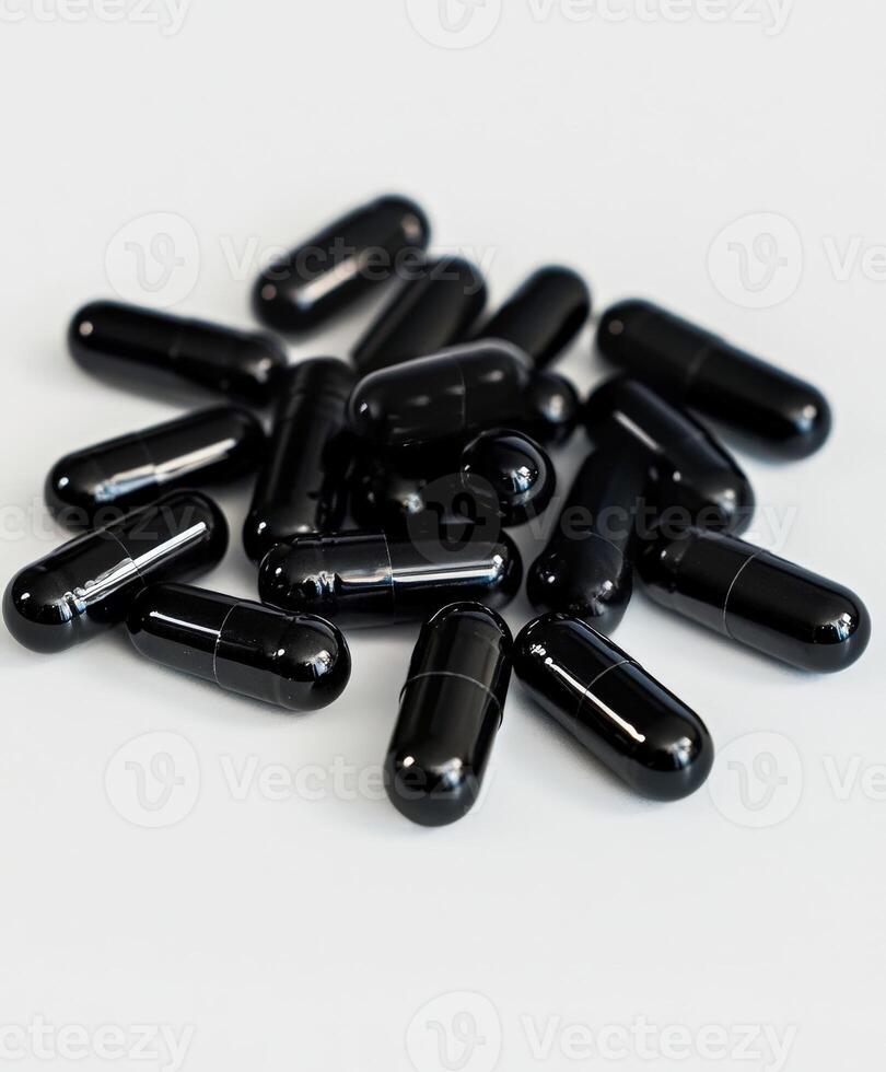Collection of black capsules arranged on a white background for display photo
