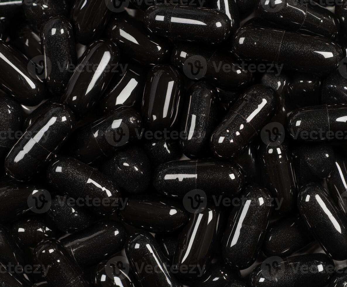 Black capsules arranged closely on a surface ready for consumption photo