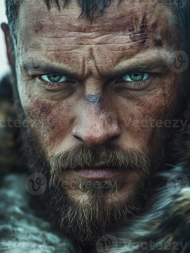 Intense portrait of a warrior in rugged attire with striking blue eyes photo