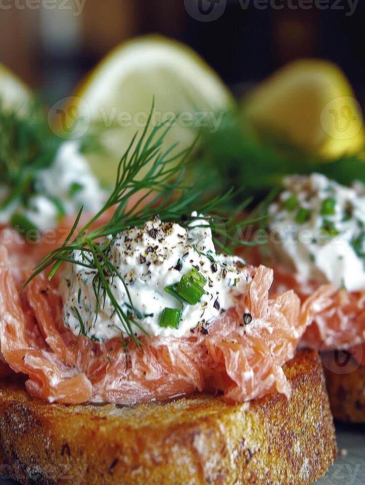 Delicious smoked salmon on toasted bread with fresh herbs and lemon slices photo