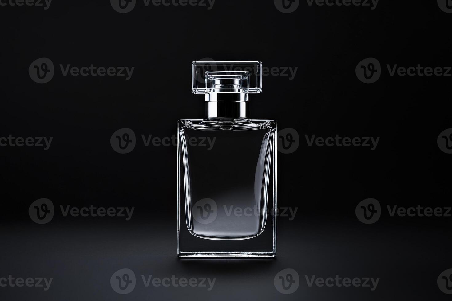 Elegant clear glass perfume bottle on a dark background photo