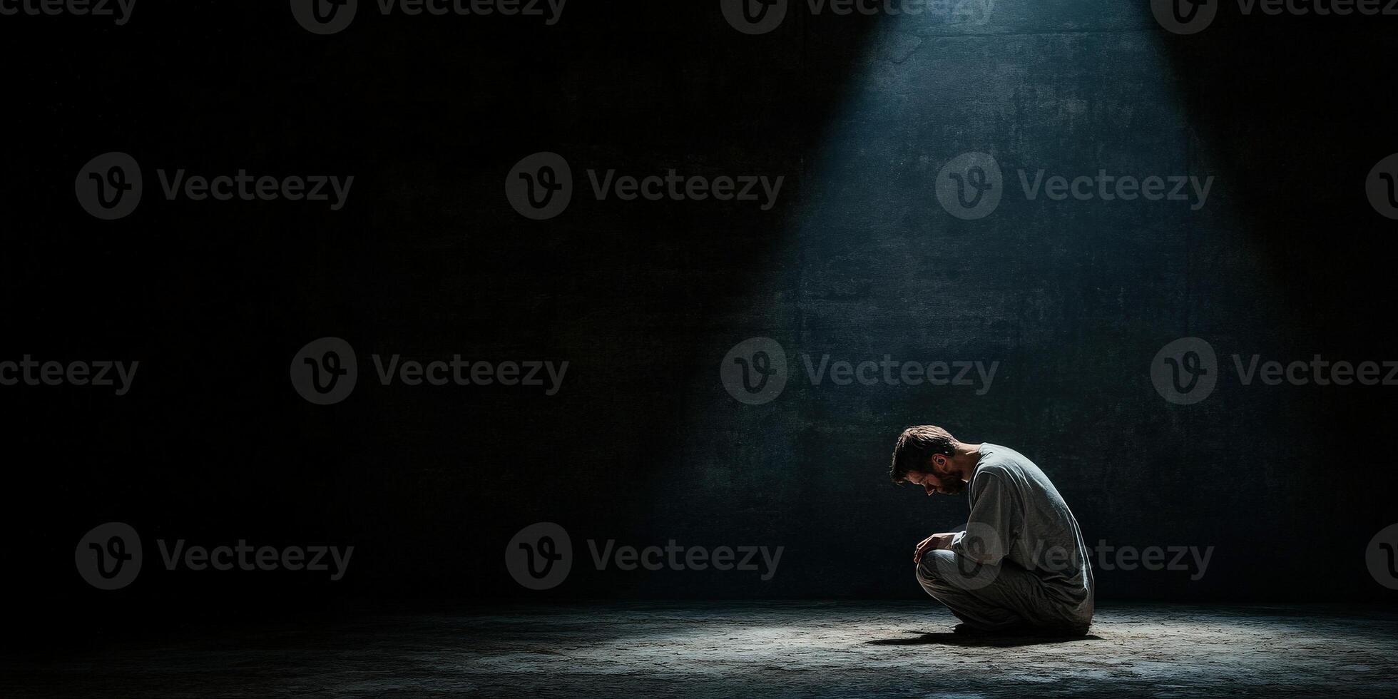 Man in a dark room experiencing solitude and reflection during a quiet moment photo