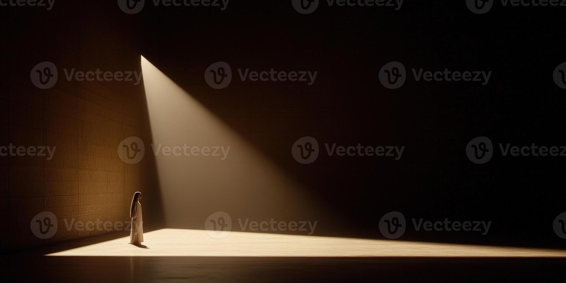 Light illuminates a figure standing in a darkened space photo