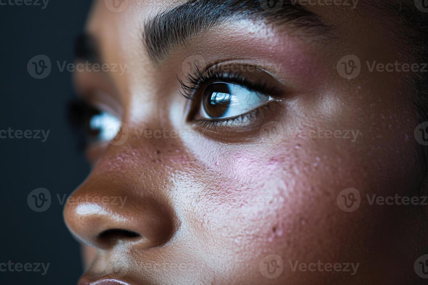 Captivating close-up of a young person's expressive eyes and skin details photo