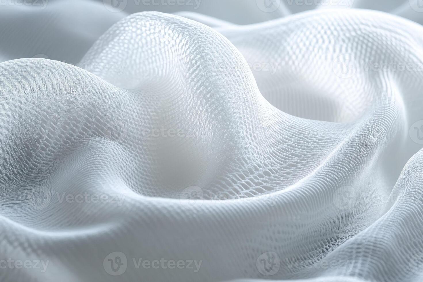 Soft white fabric drapes in gentle waves under soft light in a serene setting photo