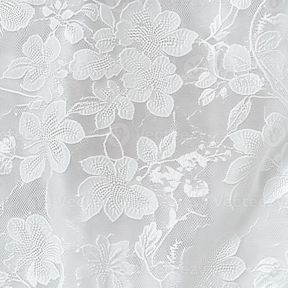 Delicate white floral lace fabric with intricate patterns on display photo