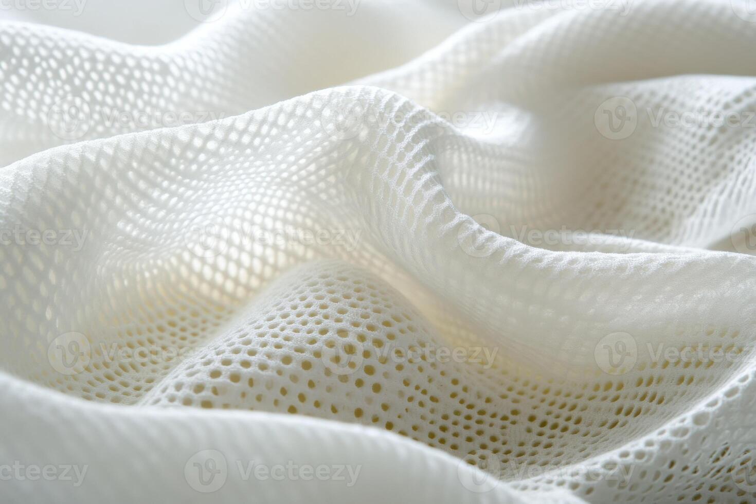 Textured white fabric creating soft folds with delicate patterns photo