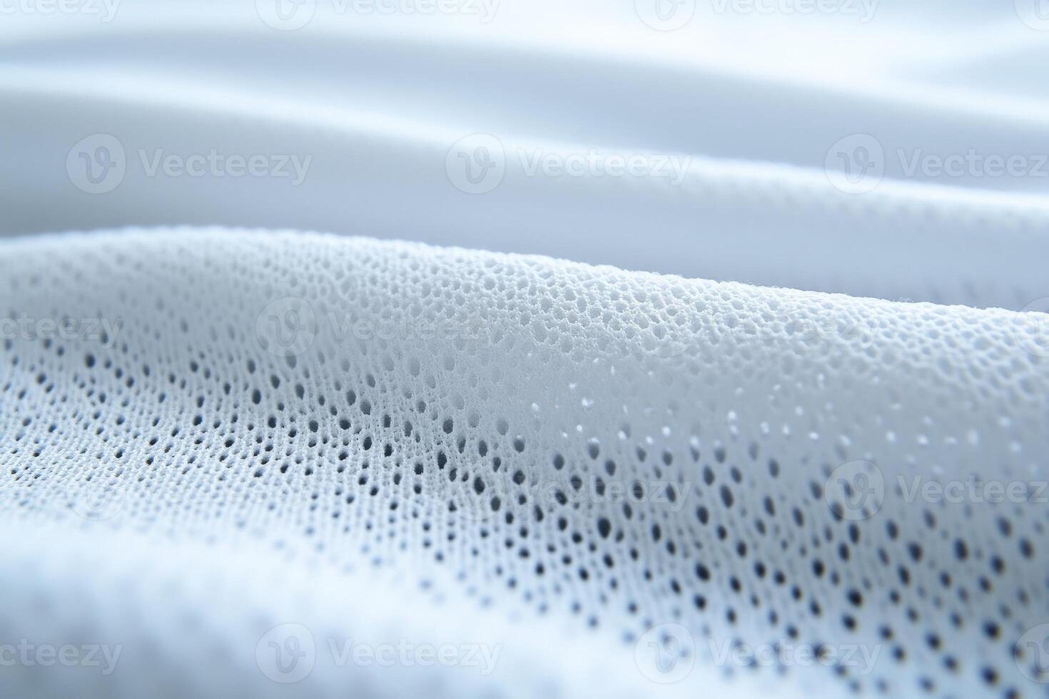 Soft white mesh fabric draped gently on a flat surface photo