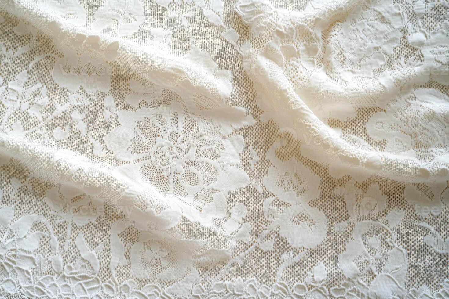 Delicate floral lace fabric draped elegantly in soft light photo
