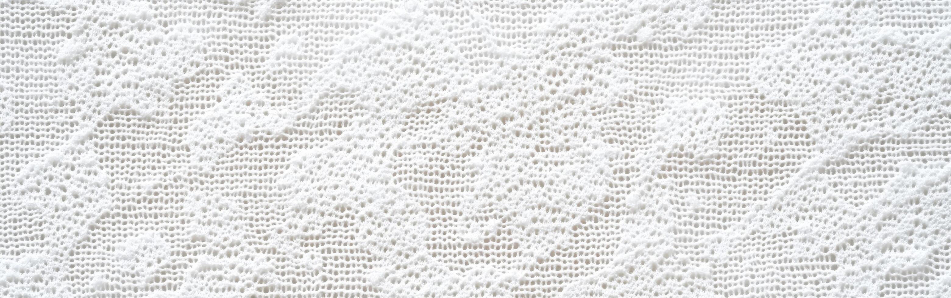 Elegant white lace fabric with intricate patterns and textures photo