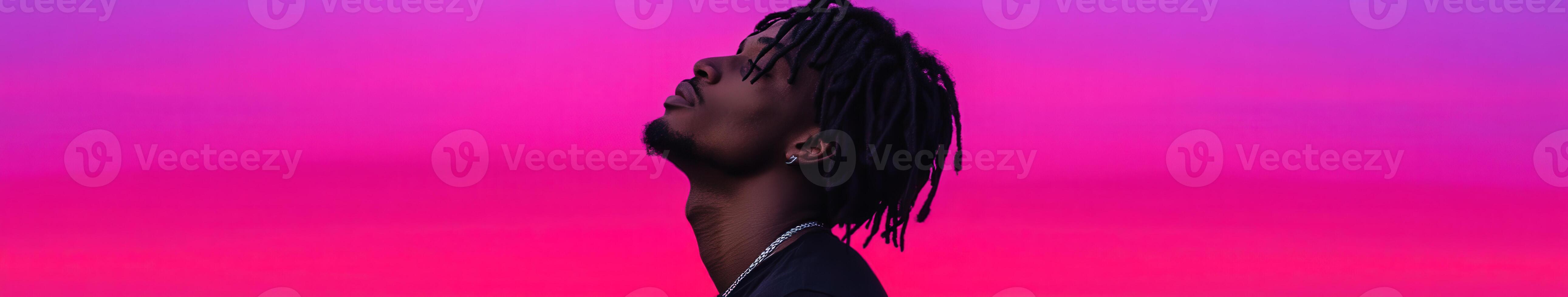 Young man enjoying the vibrant colors of a sunset with relaxed expression photo