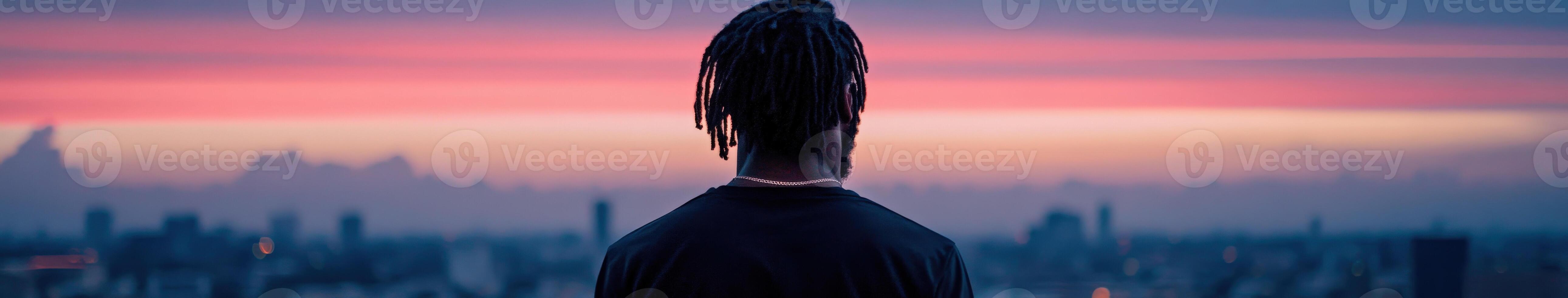 Person gazing at sunset view from a high vantage point in the city photo