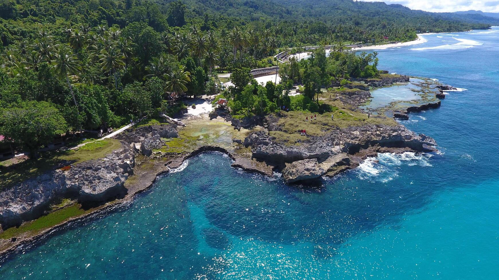 view of the coral rocks on the edge of West Papua's Biak beach as seen from above photo