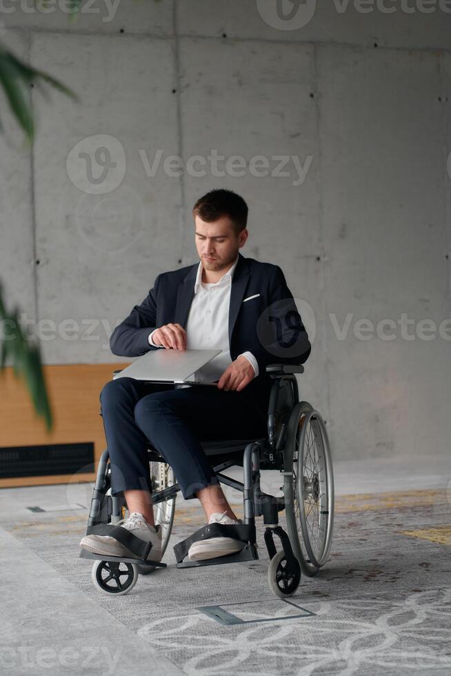 A director in a suit sitting in a wheelchair, using a ball in a modern office, embodying adaptability, focus, and leadership while navigating challenges in the workplace photo