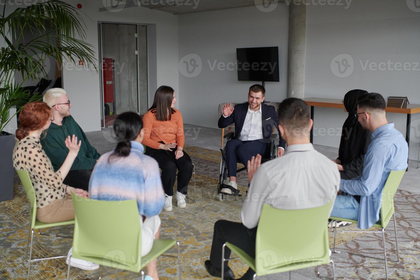 Corporate business team meeting with a manager or coach. Group of happy diverse, multiracial people sitting in a circle photo