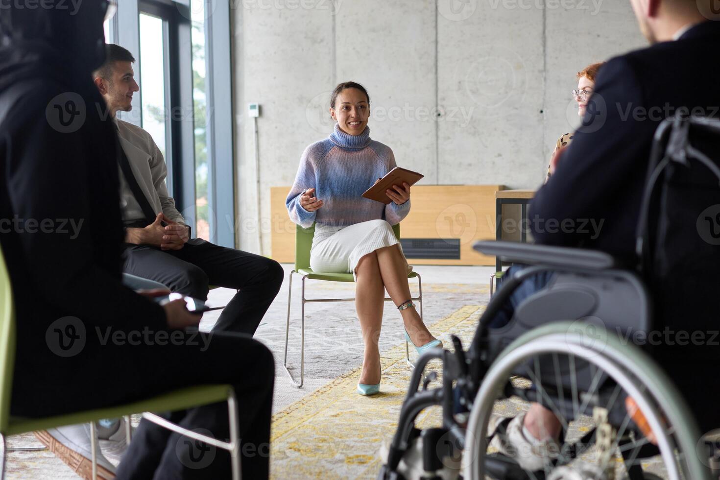 Corporate business team meeting with a manager or coach. Group of happy diverse, multiracial people sitting in a circle photo