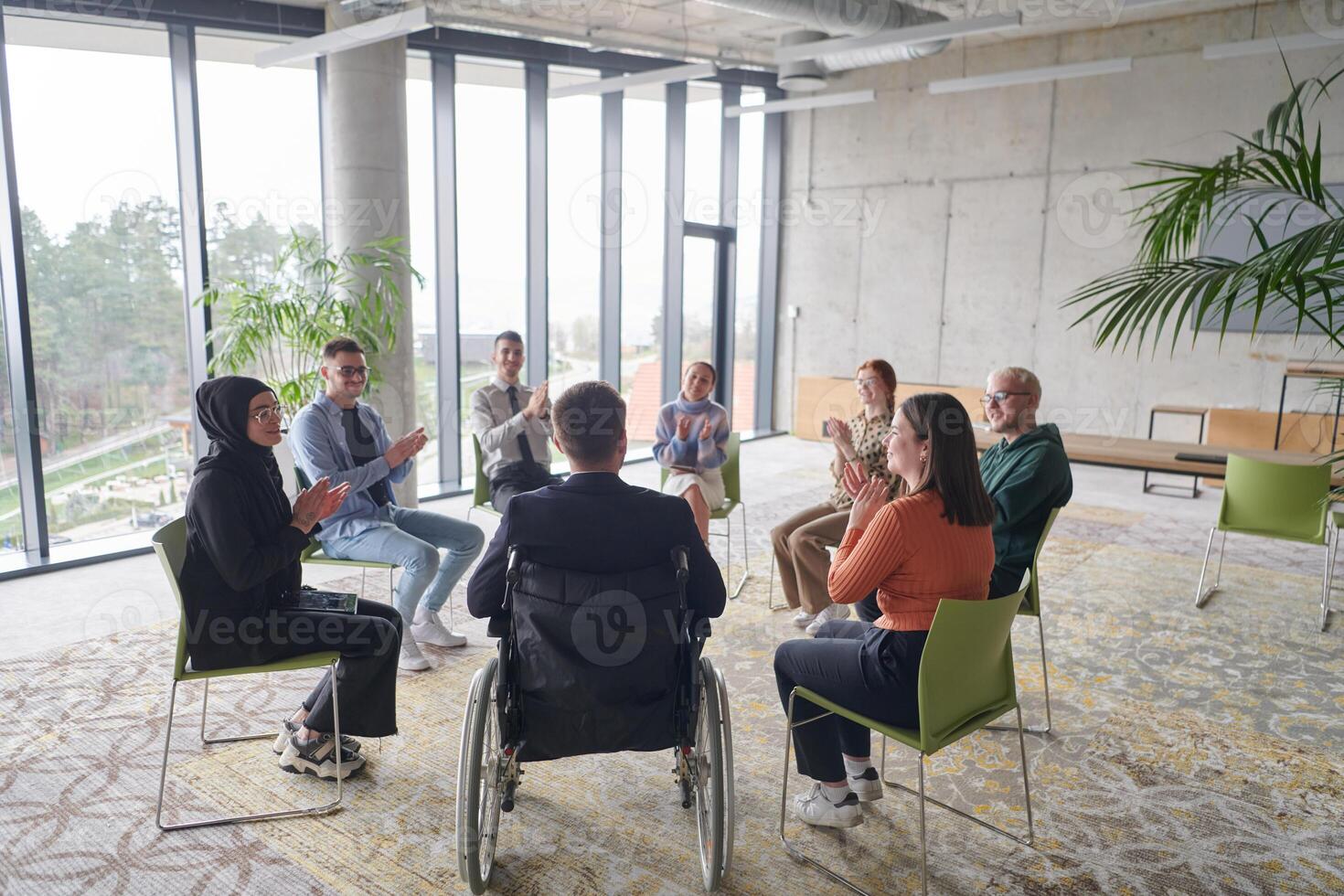 Corporate business team meeting with a manager or coach. Group of happy diverse, multiracial people sitting in a circle photo